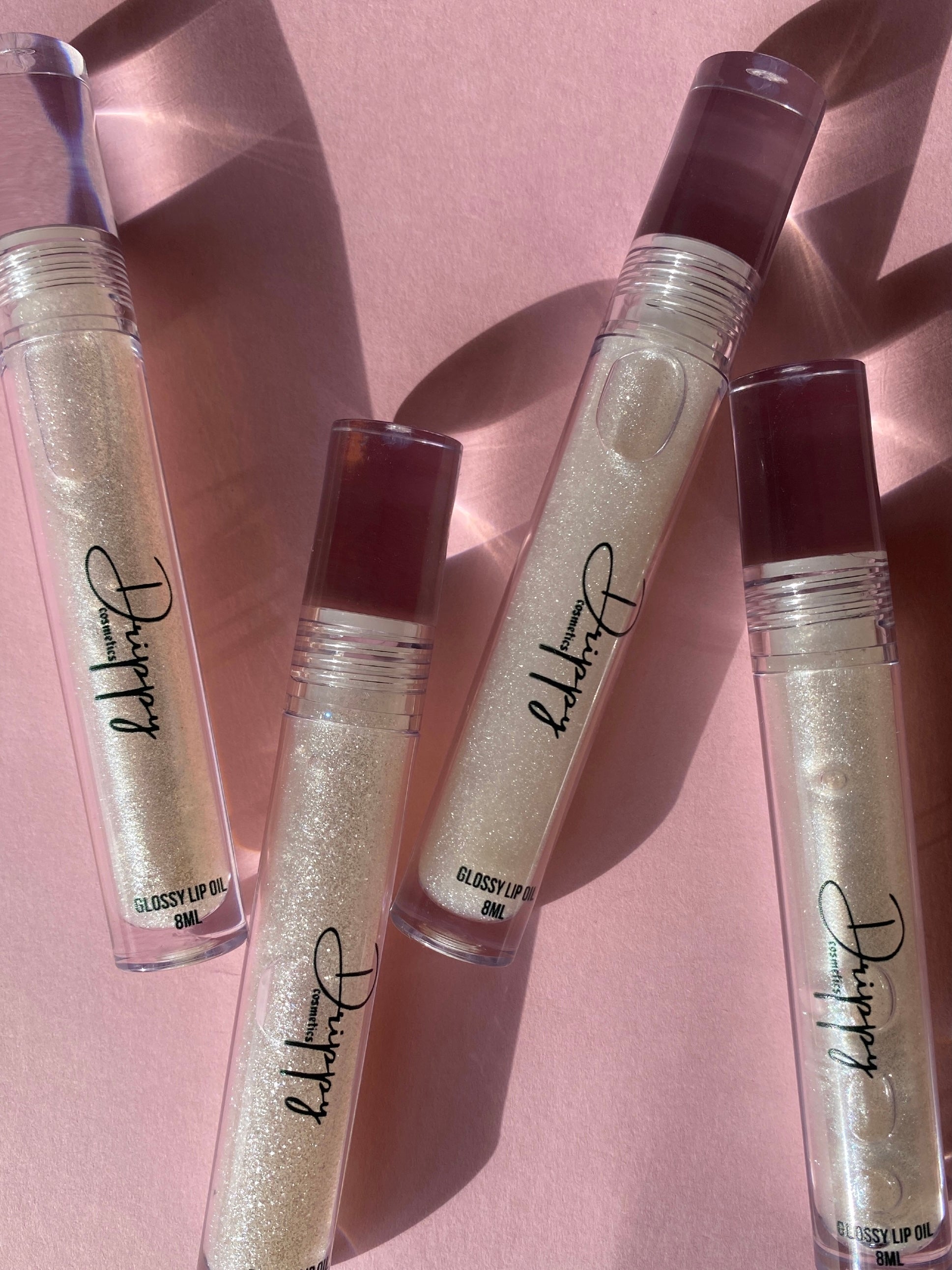 DRIPPY COSMETICSIcy Glossy Lip OilNot as thin as a lip oil &amp; not as thick and sticky as a Lip gloss. 
Our light-weight, silky formula gives you the shine of a Lip gloss with less stickiness and m